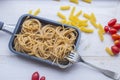 Organic whole wheat bunch of raw italian spaghetti pasta on a white table background, selective focus. Royalty Free Stock Photo