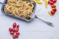 Organic whole wheat bunch of raw italian spaghetti pasta on a white table background, selective focus. Royalty Free Stock Photo