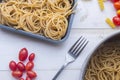 Organic whole wheat bunch of raw italian spaghetti pasta on a white table background, selective focus. Royalty Free Stock Photo