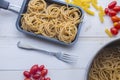 Organic whole wheat bunch of raw italian spaghetti pasta on a white table background, selective focus. Royalty Free Stock Photo