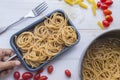 Organic whole wheat bunch of raw italian spaghetti pasta on a white table background, selective focus. Royalty Free Stock Photo