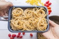 Organic whole wheat bunch of raw italian spaghetti pasta on a white table background, selective focus. Royalty Free Stock Photo