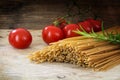 Organic wholemeal pasta, dried spaghetti, tomato and rosemary he Royalty Free Stock Photo