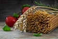 Organic wholemeal spaghetti with wheat ears, tomatoes and basil Royalty Free Stock Photo