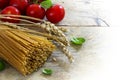 Organic wholemeal spaghetti with wheat ears, tomatoes and basil Royalty Free Stock Photo