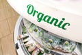 Organic word signage at supermarket vegetable fruits refrigerated aisle section