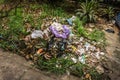 Organical and plastic waste heaps littered in a garden with bush and grass photo taken in Depok Indonesia