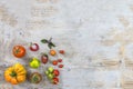 Organically grown ancient variety of tomatoes on old white wooden table with copy space