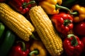 Organically Grown Fresh Farm Products. Vibrant Sweet Corn, Assorted Peppers, and Zucchini - Top View