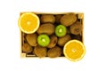 Organically grown kiwi and oranges in isolated wooden crate Royalty Free Stock Photo