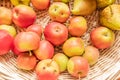 organically grown red apples in a basket of wickerwork, top view