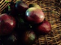 Organically home grown ripe tropical passion fruit in cane basket Royalty Free Stock Photo