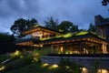 organicmodern house with green roof lit by downlights Royalty Free Stock Photo