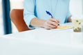 Organising her tasks for the day. a young businesswoman writing notes in an office. Royalty Free Stock Photo