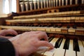 organists hands playing the keys of a large pipe organ Royalty Free Stock Photo