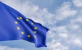 Organization flag European Union on the background of clouds, fabric flag European Union, blue sky background with European Union Royalty Free Stock Photo