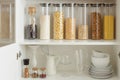 Organization of food storage in the kitchen. Collection of grain products in storage jars in pantry, zero waste smart kitchen org
