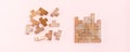 Organization and order. Wooden puzzle pieces are stacked correctly and chaotically scattered in disarray on a pink background. Web