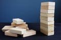 Organization, strategy and risk in business. Tower and piled up from wooden bricks