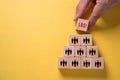 Organization and team structure symbolized with cubes and a hand putting a cube with the German word for `Let`s Go` Royalty Free Stock Photo