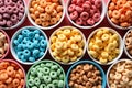 Organized display of assorted colorful breakfast cereals in individual white bowls arranged in rows, processed breakfast Royalty Free Stock Photo