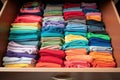 organized drawer of colorful kids t-shirts
