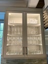 Organized glass cabinets in the kitchen of a luxury vacation rental home on Kiawah Island in South Carolina