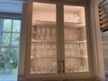 Organized glass cabinets in the kitchen of a luxury vacation rental home on Kiawah Island in South Carolina