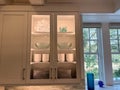 Organized glass cabinets in the kitchen of a luxury vacation rental home on Kiawah Island in South Carolina