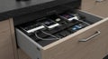 Organized kitchen drawer with charging devices Royalty Free Stock Photo