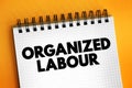 Organized Labour - workers joined through membership of trade unions, text concept on notepad
