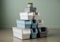 Organized pyramid stack of white and grey plastic storage bins with plant Royalty Free Stock Photo