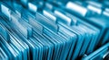 Organized rows of blue file folders with blank tabs in a filing cabinet ready for categorizing documents and office paperwork Royalty Free Stock Photo