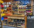 Organized shop storage area featuring bins of small parts, safety helmets, and cords wrapped up. Royalty Free Stock Photo