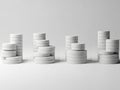 Organized stacks of white circular objects on a plain surface Royalty Free Stock Photo