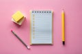 Organized workspace featuring a checklist notepad, pencils, and sticky notes on a pink surface. Generative AI Royalty Free Stock Photo