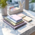 Organized workspace featuring a stack of notebooks, colorful post its and pens stationery Royalty Free Stock Photo