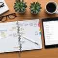Workspace featuring a weekly planner tablet and coffee cup on a Royalty Free Stock Photo