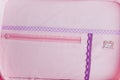 Organizer bag for storing needlework tools. Pink and purple bag with a handmade tag. Violet-pink soft fabric. Royalty Free Stock Photo