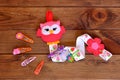 Organizer for hairpins, a felt owl, a set of barrettes. Kids crafts. Brown wooden background