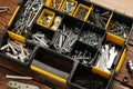 Organizer with many different fasteners and wrenches on wooden table, above view Royalty Free Stock Photo