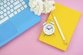 Organizer, pen, yellow diary, clock, coffee and blue notebook on pink background Royalty Free Stock Photo