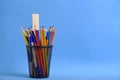 Organizer with pencils and ruler, stand for stationery form bucket blue background.