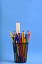 Organizer with pencils and ruler, stand for stationery form bucket blue background.