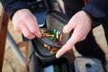 Organizer with a set of artificial lures for fishing in the hands of a fisherman. Royalty Free Stock Photo