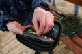 Organizer with a set of artificial lures for fishing in the hands of a fisherman.