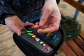 Organizer with a set of artificial lures for fishing in the hands of a fisherman.