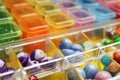 Organizers with variety of colorful beads as background, closeup