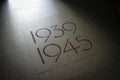 Orglandes,Normandy, France; 4 June 2014: Orglandes Cemetery. tile on the cemetery floor of Orglandes indicating the years 1939 to