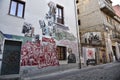 Main street in historic center of Orgosolo decorated by local artists wall paintings,